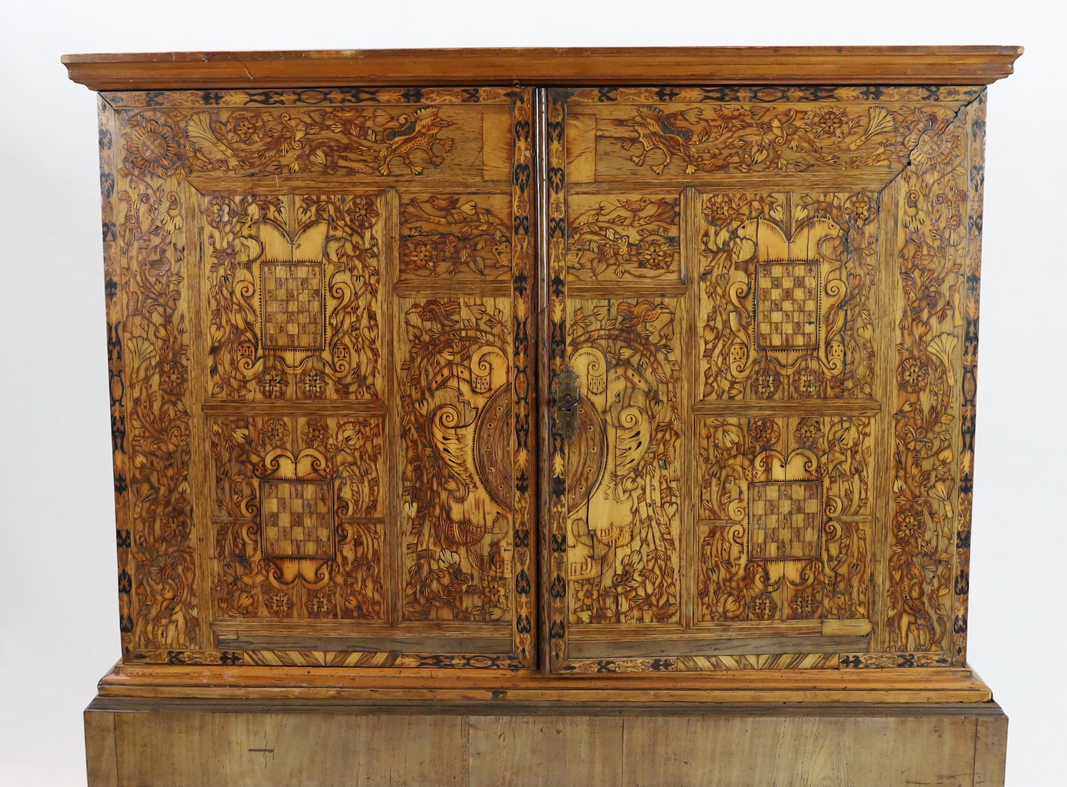 A 17th century and later South German walnut and marquetry cabinet on later stand, width 110cm, depth 53cm, height 153cm